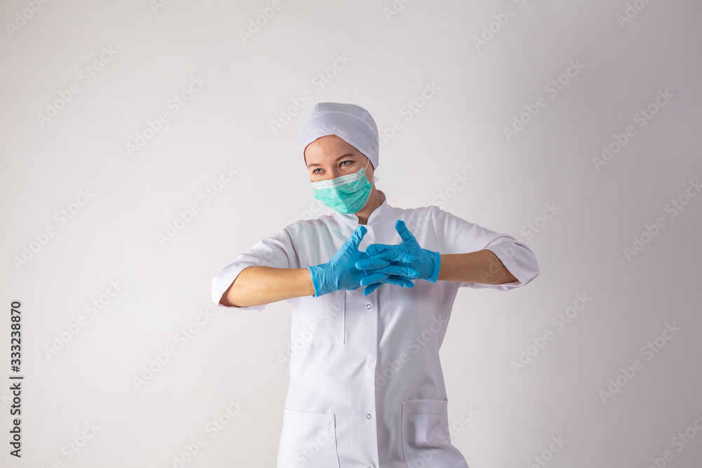Cute girl on a monophonic background shows latex gloves. Cute girl on a monophonic background shows latex gloves.