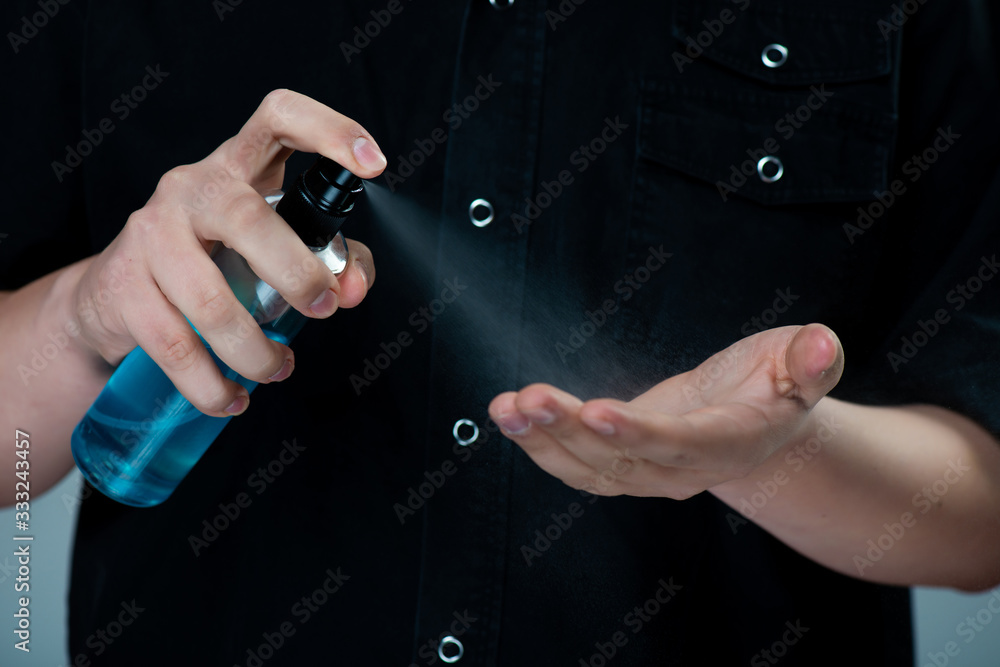 Fototapeta premium Hand applying alcohol or anti bacteria spray to prevent spread germs, bacteria and virus. Personal hygiene. Covid-19 Coronavirus disinfection concept
