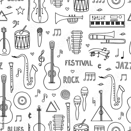 Musical background. Seamless pattern with hand drawn doodle musical instruments on white background. 