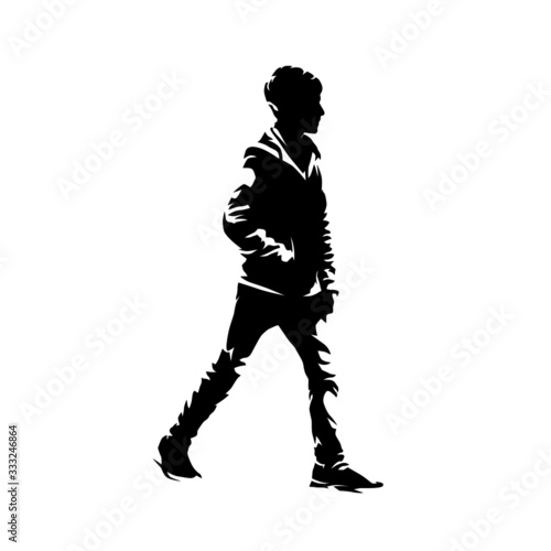Walking boy, side view. Isolated vector silhouette. Young student going with hands in pockets. Ink drawing