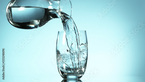 Obraz na plátně Freeze motion of pouring water from carafe