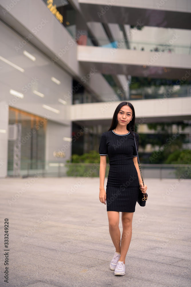 Young beautiful Asian tourist woman at the mall outdoors Young beautiful Asian tourist woman at the mall outdoors