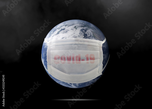 On planet earth, a medical mask to protect against the coronavirus epidemic. Concept of a global virus epidemic, concept of Corona virus quarantine, Covid-19. Elements of this image furnished by NAZA photo