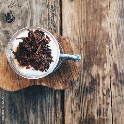 Coffee on wooden coaster with cholocate photo