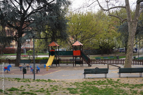 Europe, Italy Milan march 2020 - closure of schools and playgrounds for children in parks - play areas blocked by police tapes by order of the municipality 