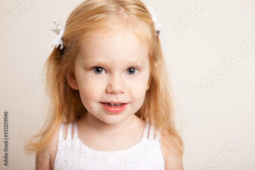 Portrait of Happy Little Blond Girl Smiling