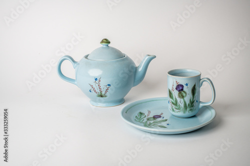 teapot and cup on white background