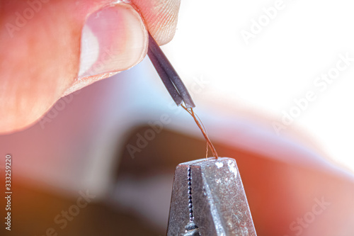 wire stripping with pliers close up. professional at work.