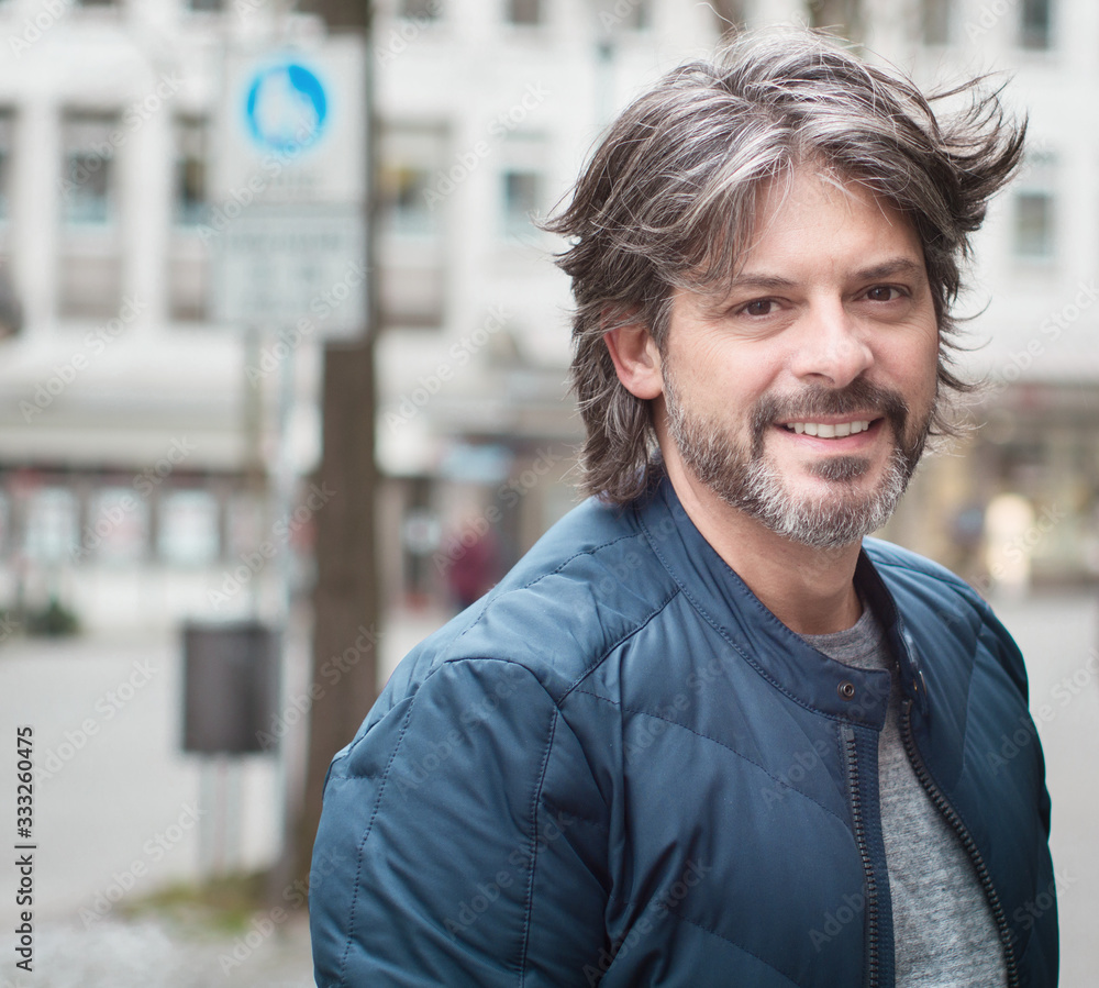 Close-up adult smile man with beard looking to camera Close-up adult smile man with beard looking to camera