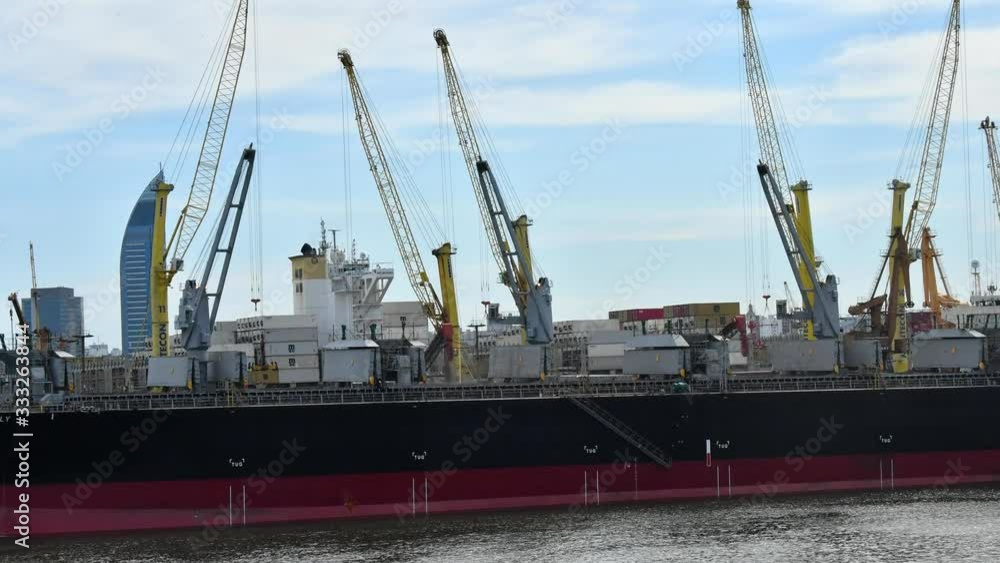 Timelapse of a cargo ship being loaded by several cranes. Timelapse of a cargo ship being loaded by several cranes.