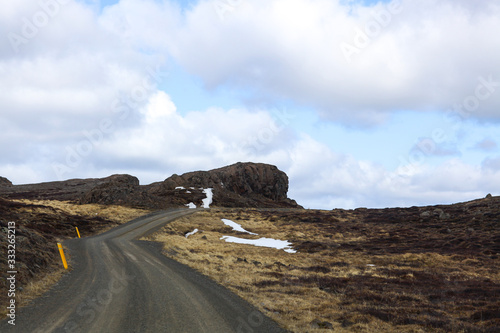 Curved road between lava fields. Country road to nowhere