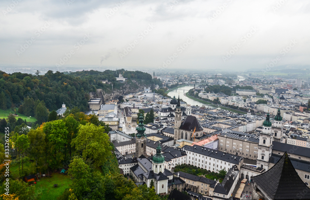 Panoramic view of Salzburg with Salzach river and Mirabell Garden from Festung Hohensalzburg in cloudy rainy day. Austria