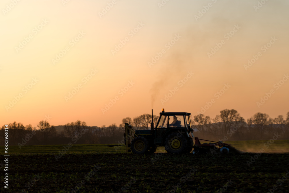 tractor farming sunset