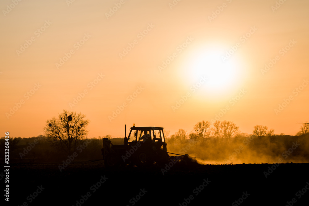 Fototapeta premium tractor farming sunset