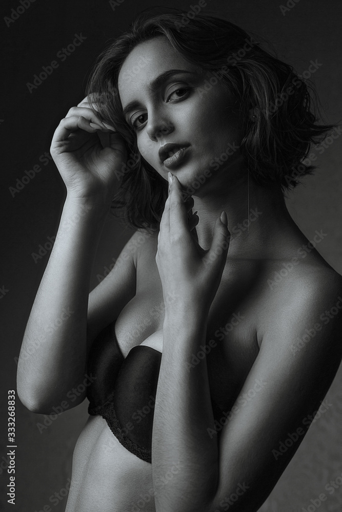Wonderful model wears lingerie posing in the dark studio Wonderful model wears lingerie posing in the dark studio