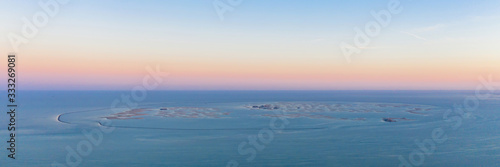 Canvas Print Aerial view of The World Islands on Dubai sea with sunset sky, United Arab Emirates or UAE