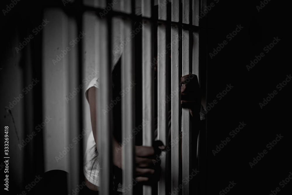 Hands of women desperate to catch the iron prison,prisoner concept,thailand people,Hope to be free,If the violate the law would be arrested and jailed.