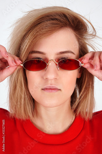 Vertical portrait - girl in red glasses, woman on a white background