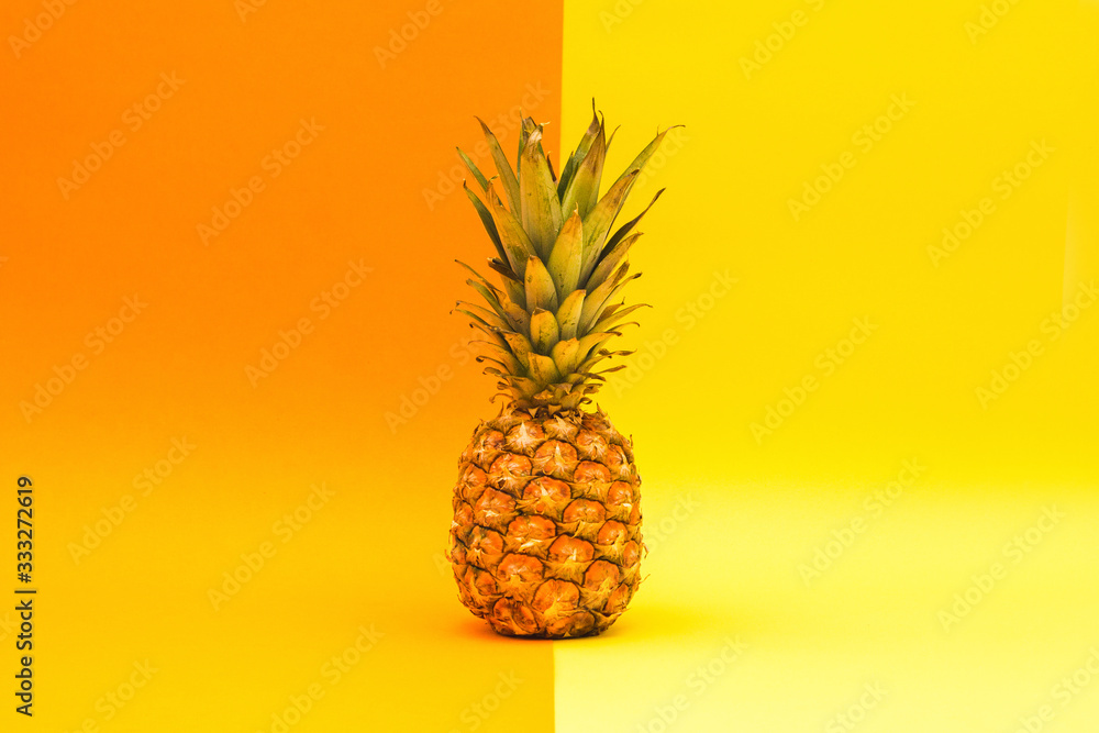 Fresh pineapple on an orange and yellow background