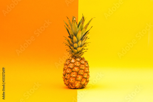 Fresh pineapple on an orange and yellow background