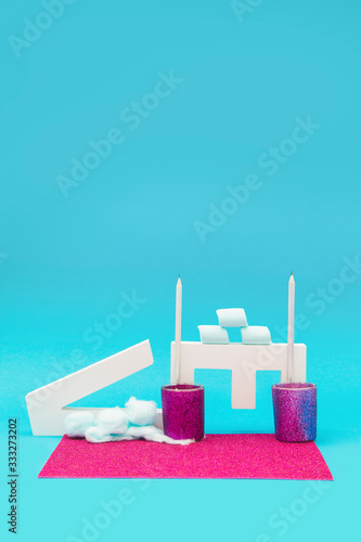 Letter objects with marshmallows and candle holders on a blue and purple background photo