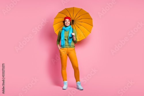 Full length photo of cheerful lovely charming girl hold her shine parasol protect her look copyspace enjoy rainy holidays wear headwear jumper isolated over pink color background