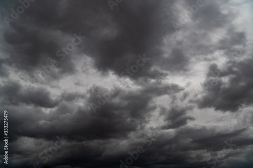 Storm is coming. Before heavy rain storm. On the sky is covered all over by the clouds. A lot of lightning and strong wind. The dark clouds is look like a big black smoke from erupting volcano
