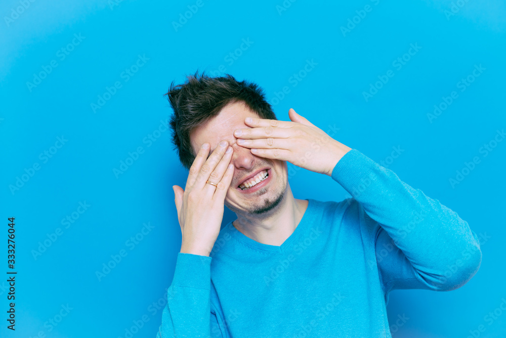 Man closes eyes with her hands Man closes eyes with her hands