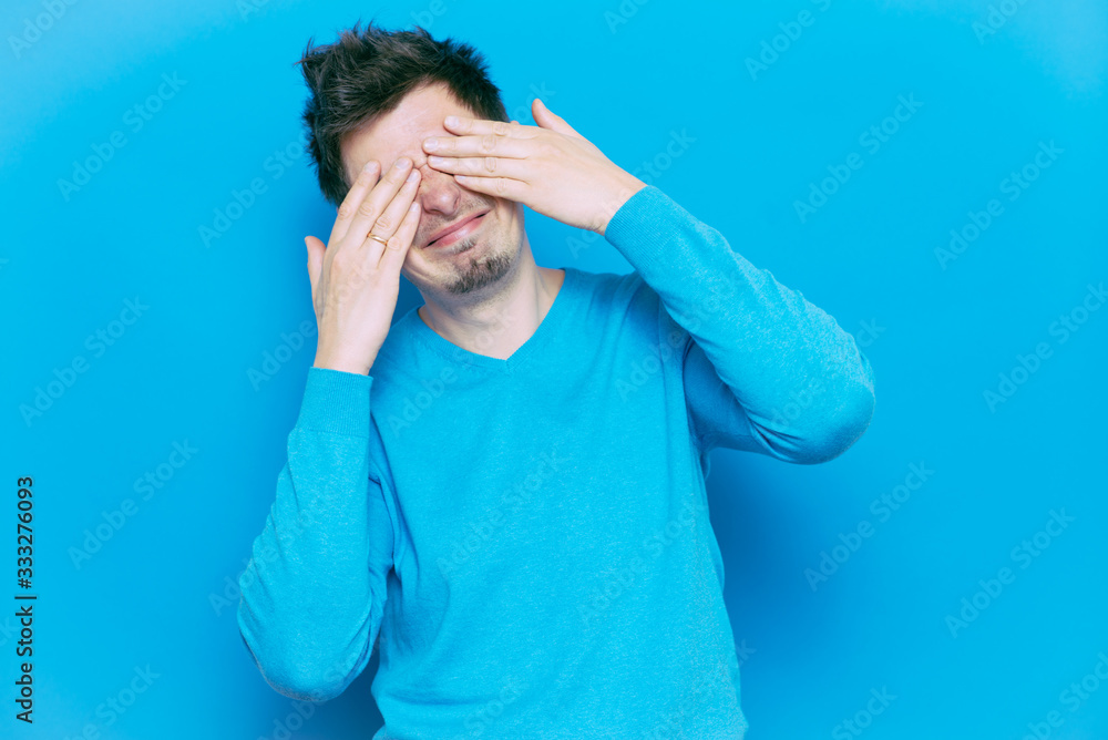 Man closes eyes with her hands Man closes eyes with her hands