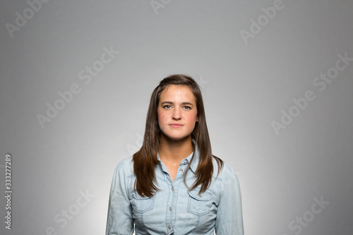 studio portrait of a young woman contemplating
