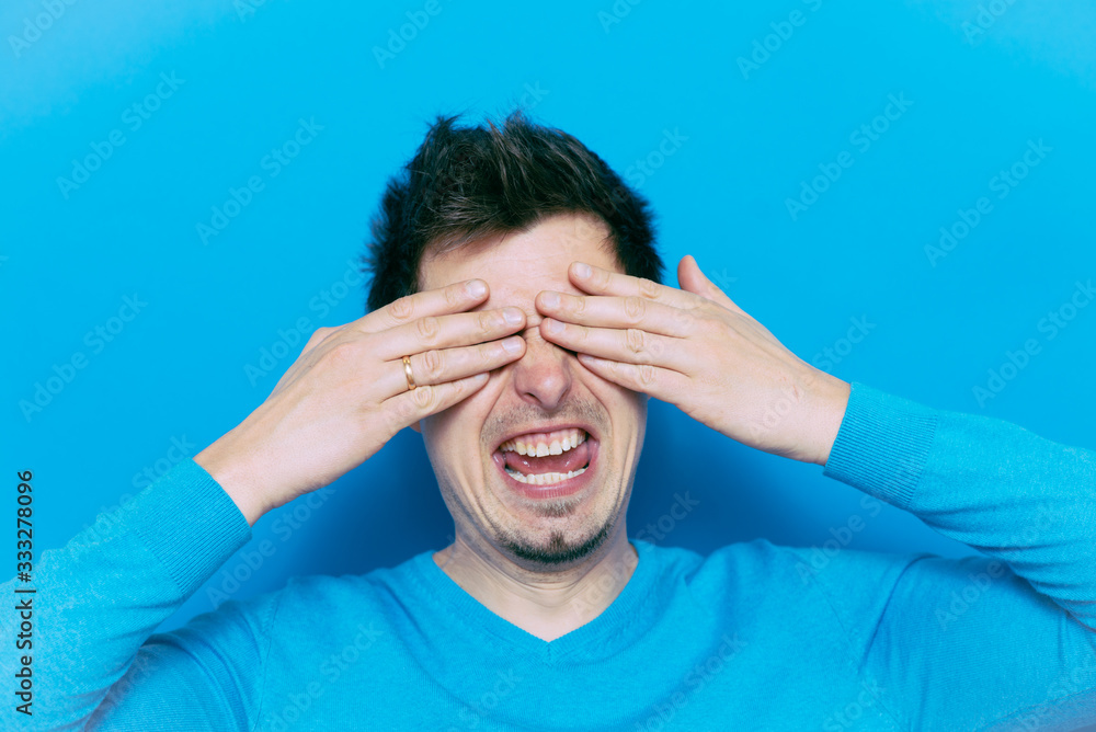 Man closes eyes with her hands