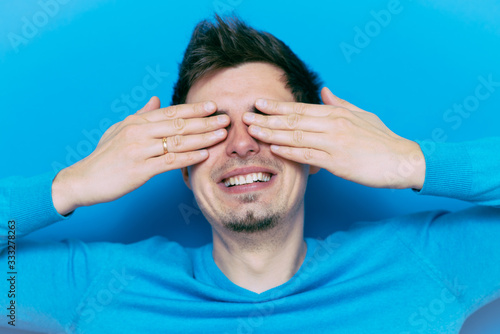 Man closes eyes with her hands