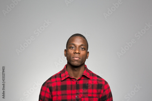 studio portrait of a young man contemplating