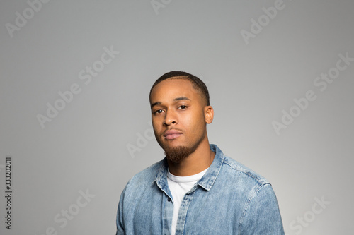 studio portrait of a young man contemplating