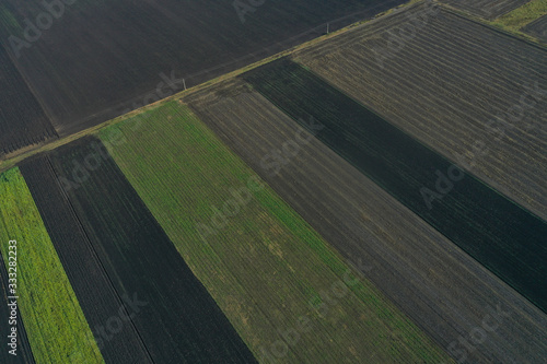 Aerial top view of different agricultural fields in countryside. Drone shot on a spring day
