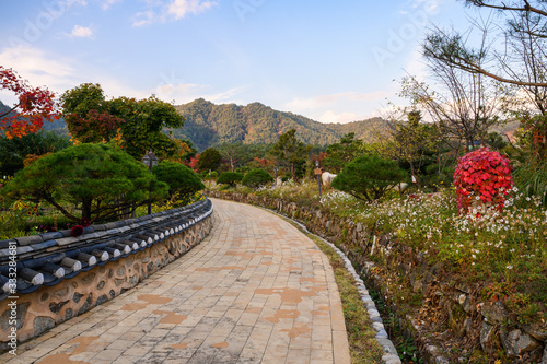 Ornamental garden with curved pathway and mountain background