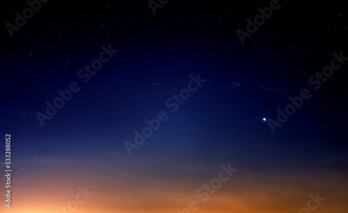Tablou canvas blue starry sky landscape at dusk against red sunset clouds background wide view
