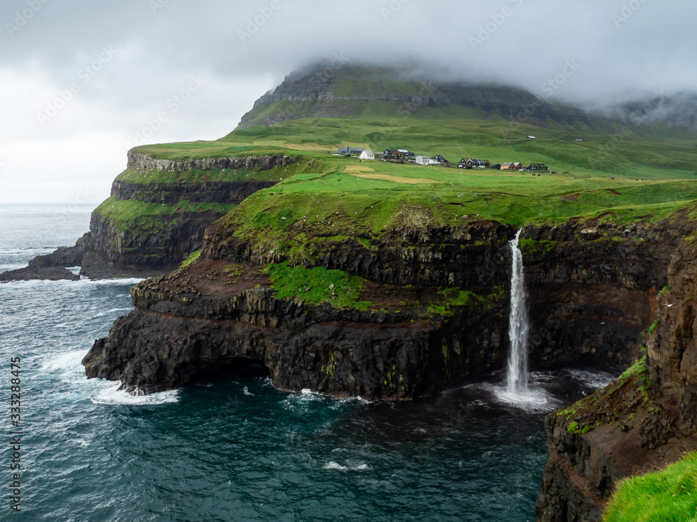 Faroe Islands. Múlafossur Waterfall. Vertical. Long exposure.