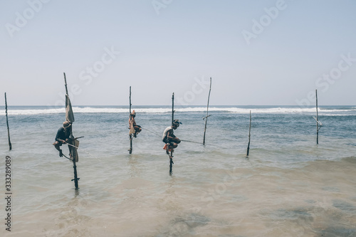 Pole fishermen in the ocean Sri Lanka