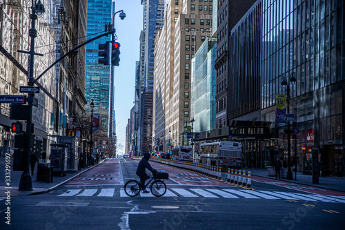 A person rides his bike through the near empty streets near Grand Central due to health concerns to stop the spread of Coronavirus in New York City on Tuesday, March 24, 2020. (Photo: Gordon Donovan). photo