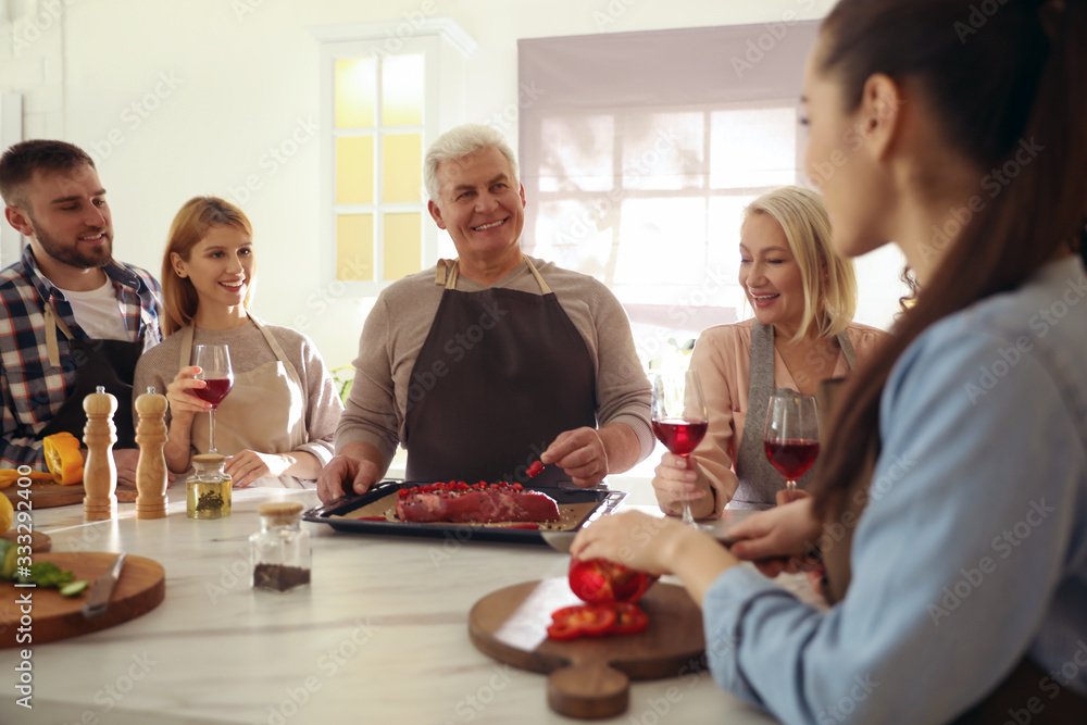 Happy people cooking food together in kitchen Happy people cooking food together in kitchen