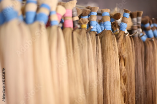 Various colors of straight single clip in human hair extensions. Making natural wigs.