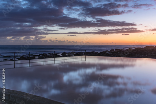 Sunrise and Cloud Reflections in the Sea Pool