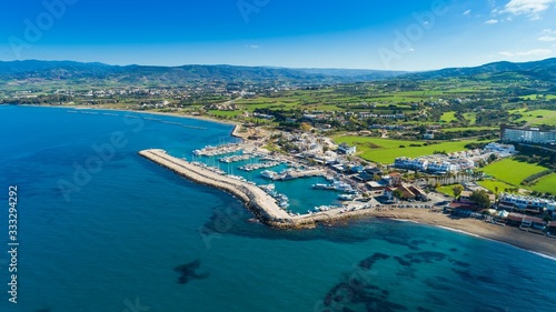 Aerial bird's eye view of Latchi port,Akamas peninsula,Polis Chrysochous,Paphos,Cyprus. The Latsi harbour with boats and yachts, fish restaurant, promenade, beach tourist area and mountains from above © f8grapher