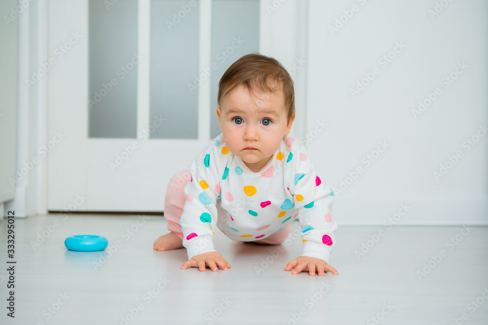 Toddler girl plays educational games at home. Baby sits on the floor of the house Toddler girl plays educational games at home. Baby sits on the floor of the house