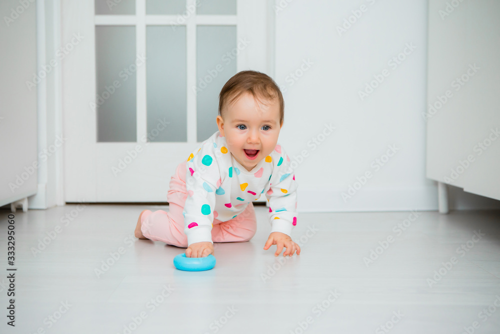 Toddler girl plays educational games at home. Baby sits on the floor of the house Toddler girl plays educational games at home. Baby sits on the floor of the house