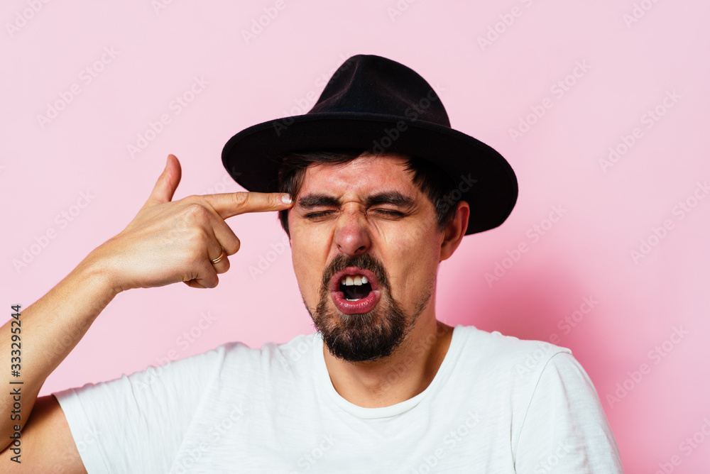 Closeup portrait of angry man gesturing with his finger against his temple, are you crazy? Closeup portrait of angry man gesturing with his finger against his temple, are you crazy?