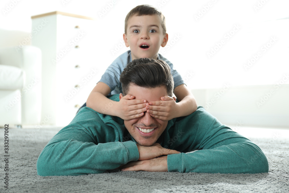 Fototapeta premium Dad and son spending time together at home. Happy Father's Day