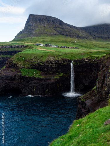 Fotografija Faroe Islands, famouse Mulafossur Waterfall, its water falling into the ocean