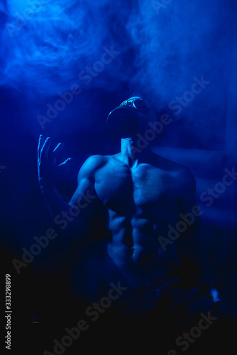 man in gas mask covered with smoke